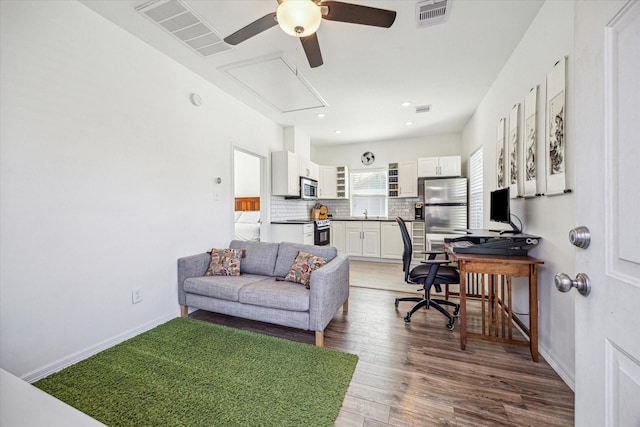 home office with hardwood / wood-style flooring and ceiling fan