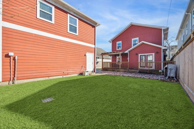 back of property with a yard and a pergola