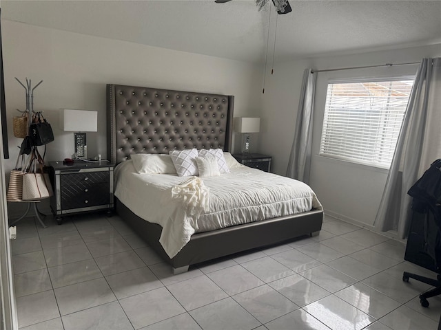 bedroom featuring light tile patterned flooring and ceiling fan