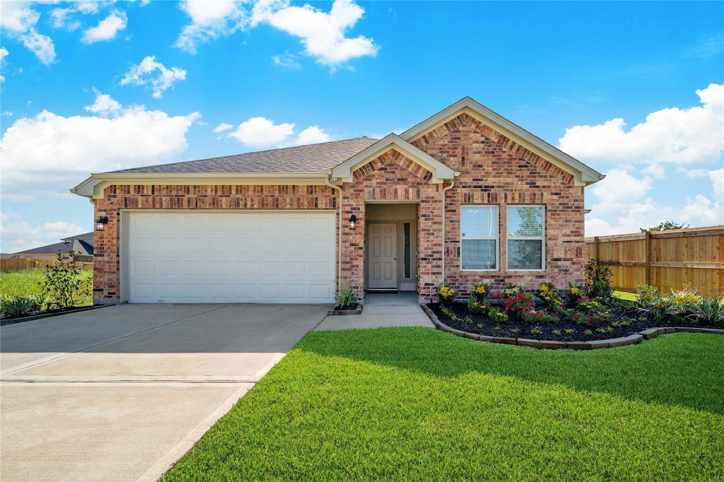 view of front of home featuring a garage and a front yard