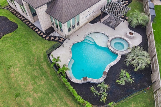 view of pool with an in ground hot tub, a lawn, and a patio