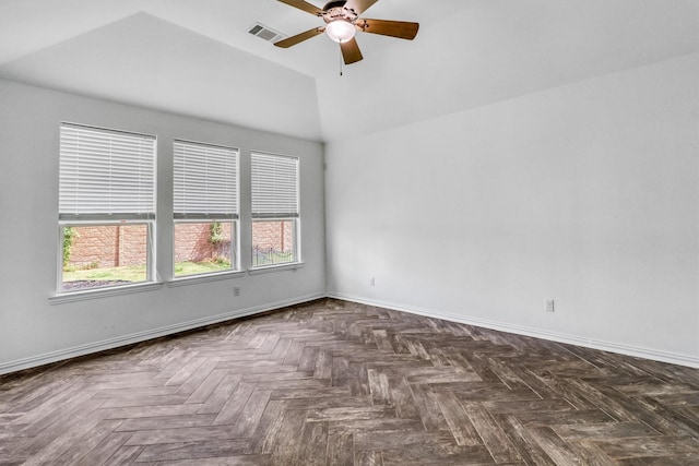 spare room with ceiling fan, dark parquet flooring, and lofted ceiling