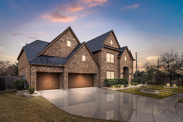 view of front of property with a garage and a yard