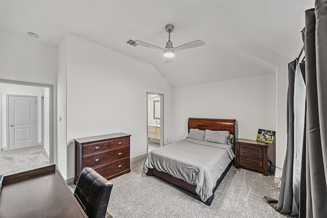 bedroom featuring lofted ceiling, light colored carpet, connected bathroom, and ceiling fan