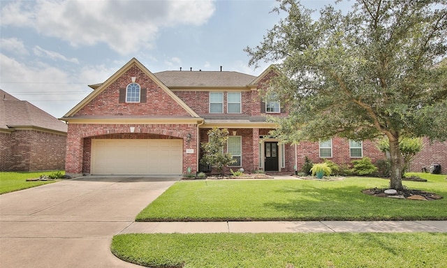 view of front of property with a garage and a front lawn