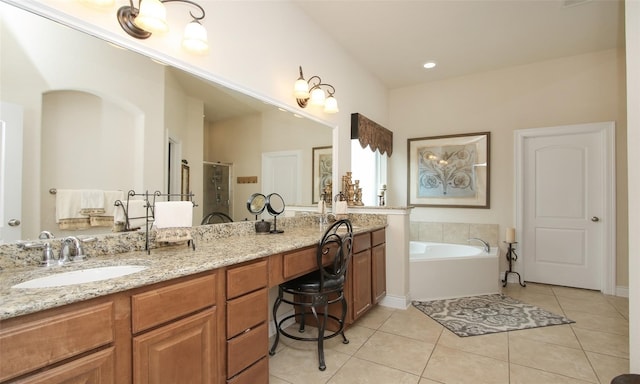 bathroom with independent shower and bath, tile patterned floors, and vanity