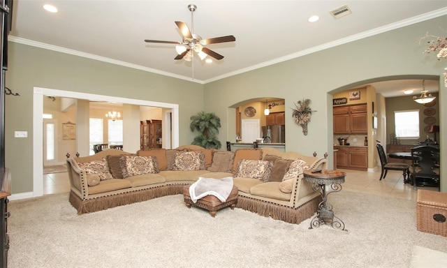 living room featuring crown molding, ceiling fan with notable chandelier, and light tile patterned floors