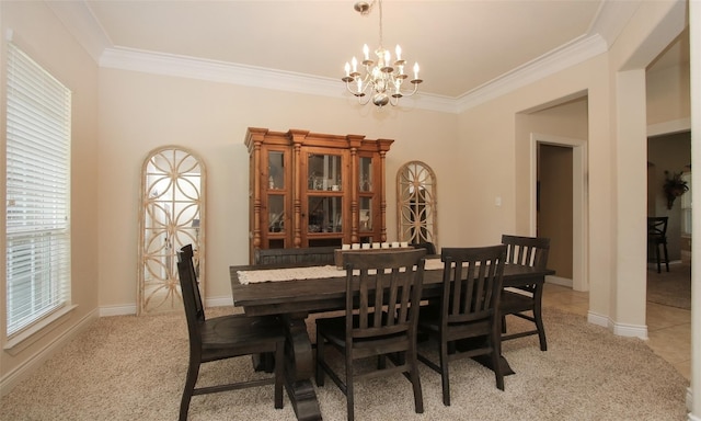 carpeted dining space featuring a chandelier and ornamental molding