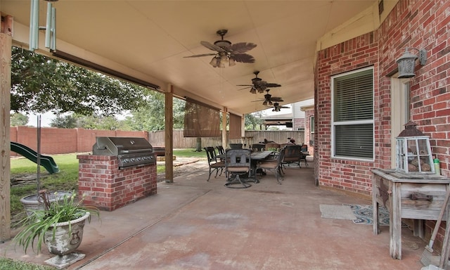 view of patio with exterior kitchen, ceiling fan, and area for grilling