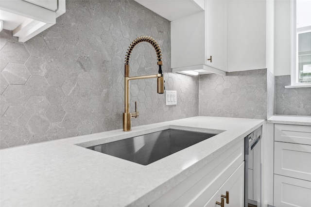 kitchen featuring white cabinetry and sink