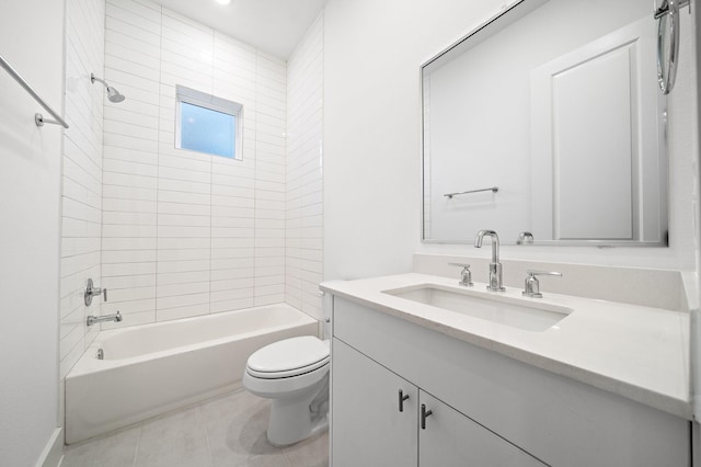 full bathroom featuring vanity, tiled shower / bath, tile patterned floors, and toilet