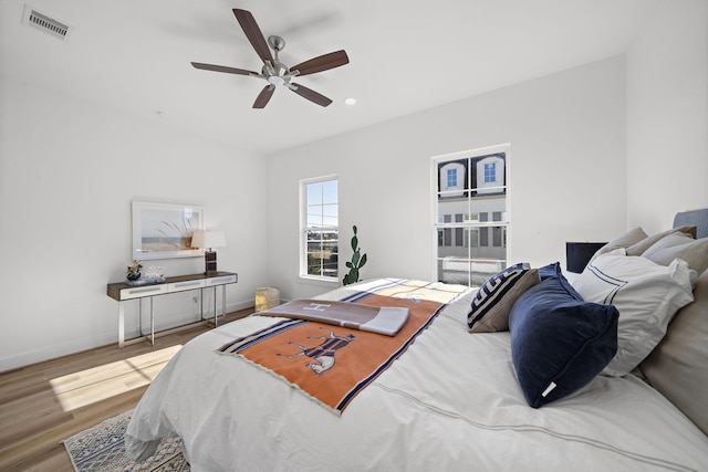 bedroom with ceiling fan and hardwood / wood-style floors