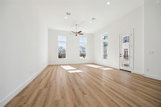 unfurnished living room featuring ceiling fan and light hardwood / wood-style flooring