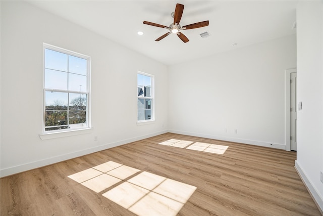 empty room with ceiling fan and light wood-type flooring