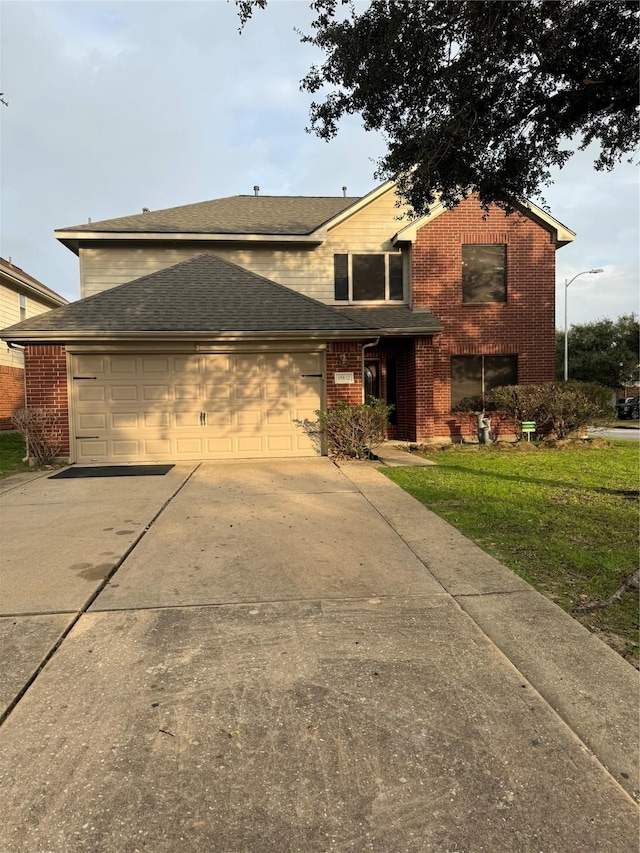 view of front facade with a garage and a front lawn