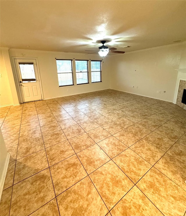 interior space featuring ceiling fan, a textured ceiling, light tile patterned floors, and a fireplace