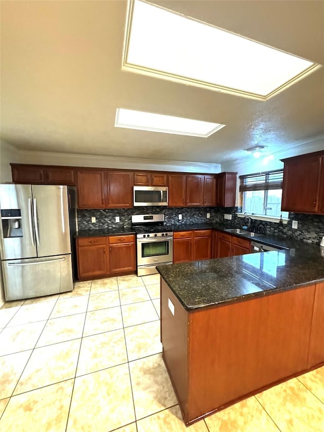 kitchen with kitchen peninsula, light tile patterned flooring, sink, and stainless steel appliances