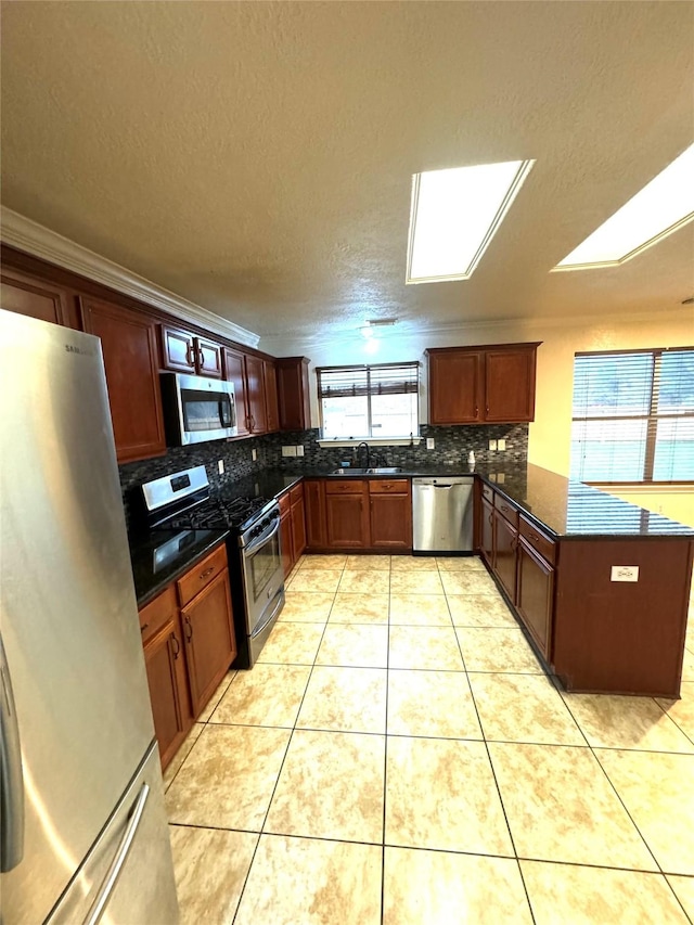 kitchen featuring crown molding, sink, light tile patterned floors, and stainless steel appliances