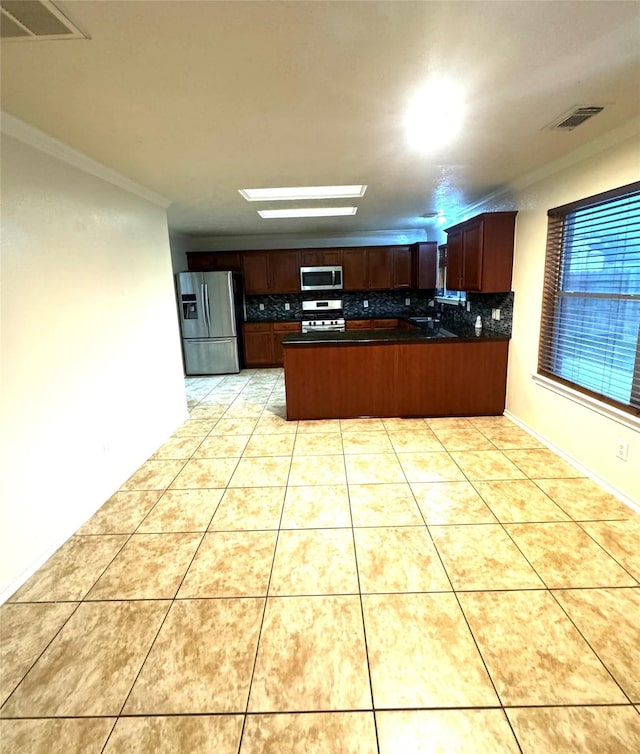 kitchen featuring crown molding, appliances with stainless steel finishes, light tile patterned floors, sink, and kitchen peninsula