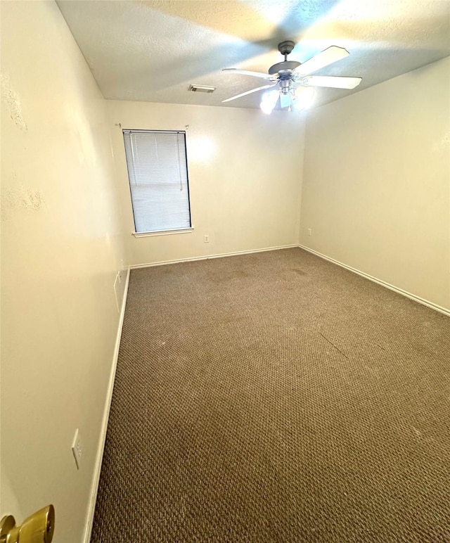 spare room with carpet, a textured ceiling, and ceiling fan