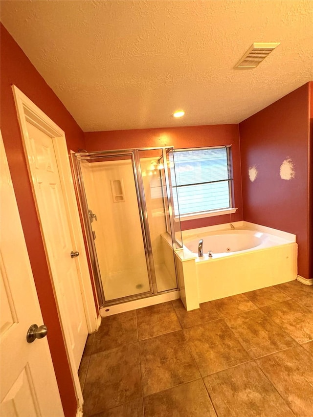 bathroom featuring independent shower and bath, a textured ceiling, and tile patterned floors