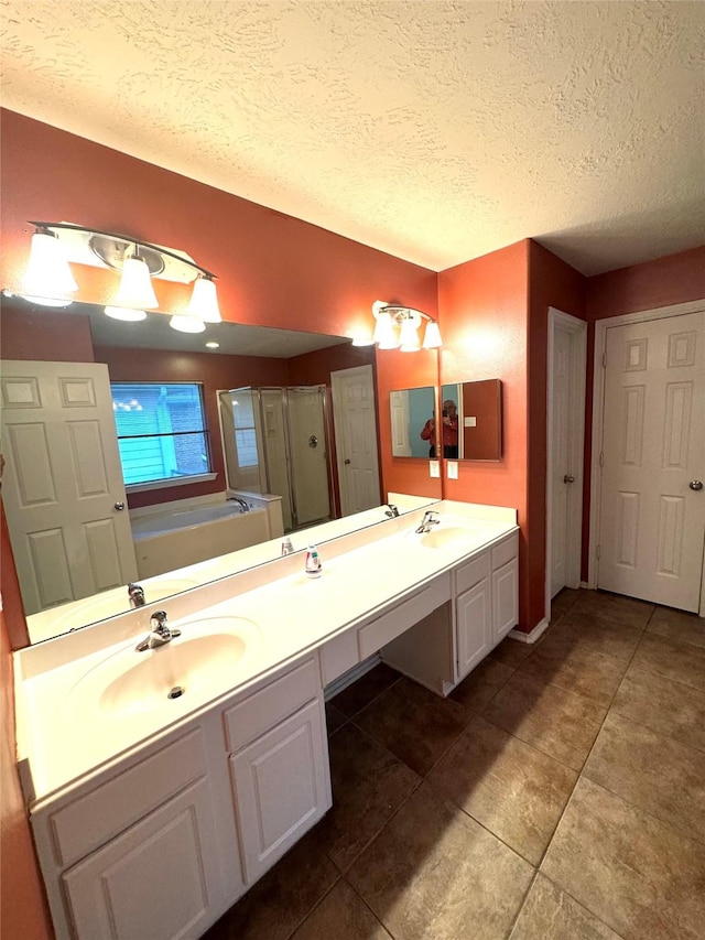 bathroom featuring a textured ceiling, vanity, and shower with separate bathtub