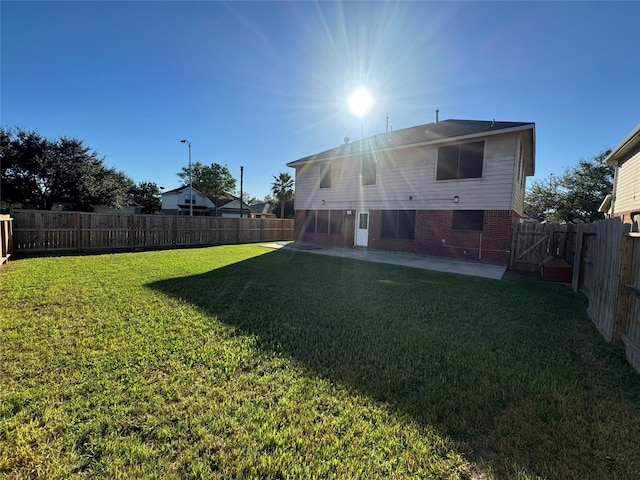 back of property featuring a patio area and a yard