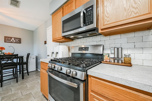 kitchen with backsplash and stainless steel appliances