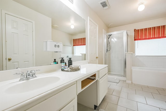 bathroom with tile patterned flooring, shower with separate bathtub, and vanity