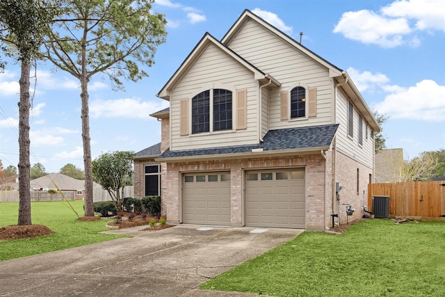 view of front of house with cooling unit, a garage, and a front yard