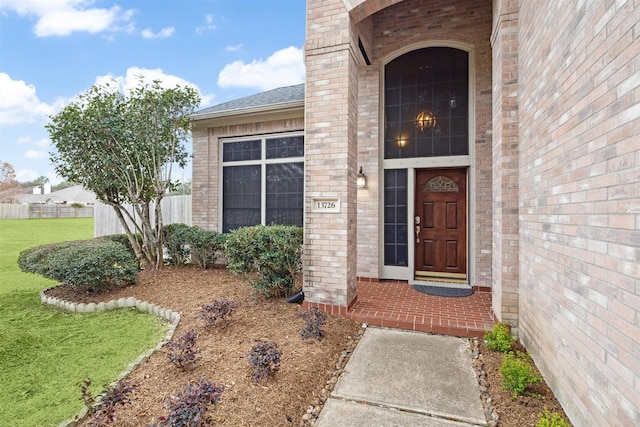 doorway to property featuring a lawn