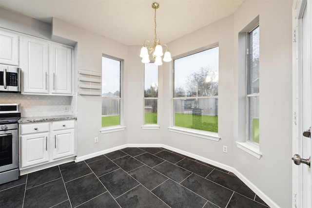 interior space featuring dark tile patterned flooring and a notable chandelier