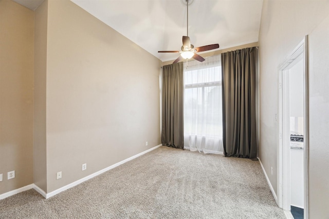 unfurnished room with ceiling fan, lofted ceiling, and carpet floors