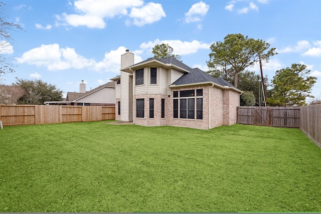 back of house with a lawn