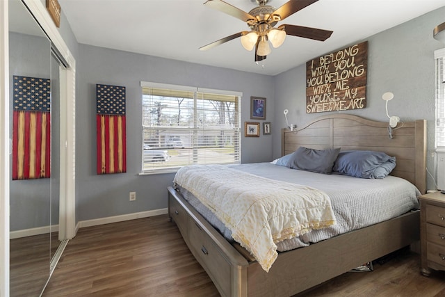 bedroom featuring dark wood-type flooring, a closet, and ceiling fan