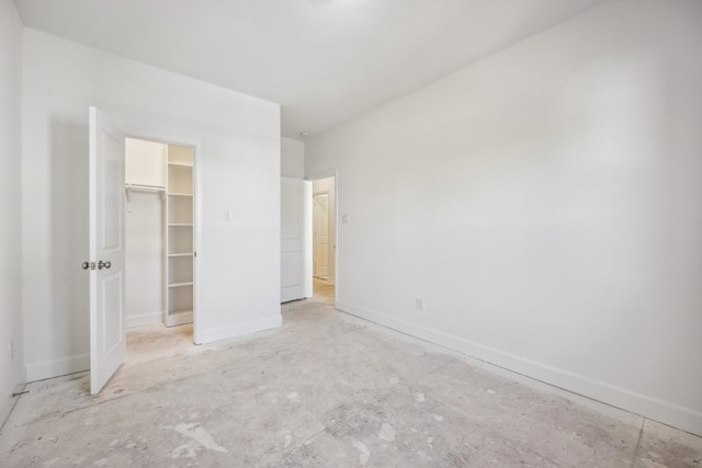 unfurnished bedroom featuring a closet and a spacious closet