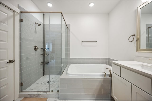 bathroom featuring vanity and separate shower and tub