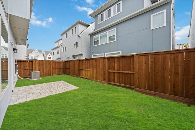 view of yard featuring a patio and central AC