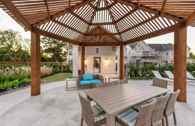 view of patio with outdoor dining area, fence, and a pergola