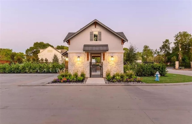 view of building exterior with driveway and fence