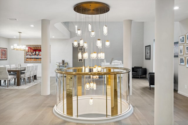 interior space with light hardwood / wood-style floors and a notable chandelier