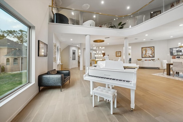 interior space featuring light hardwood / wood-style floors and a towering ceiling