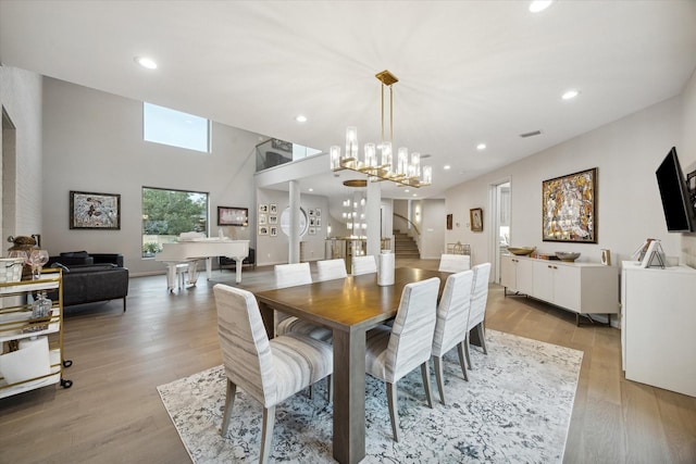 dining room featuring light hardwood / wood-style flooring and an inviting chandelier