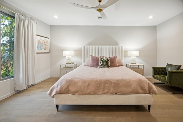 bedroom with ceiling fan and light hardwood / wood-style floors