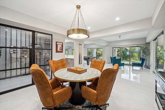 dining room with ceiling fan and ornate columns