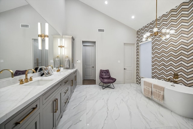 bathroom with vanity, a bathtub, and high vaulted ceiling