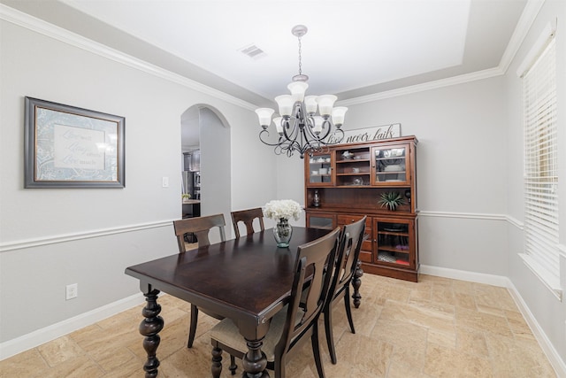 dining area featuring a chandelier and ornamental molding