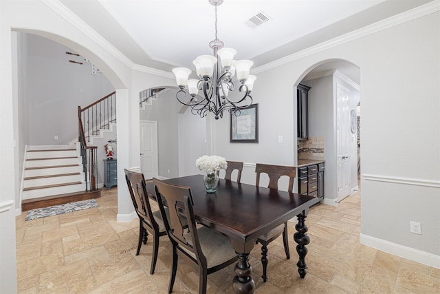 dining area featuring a chandelier and ornamental molding