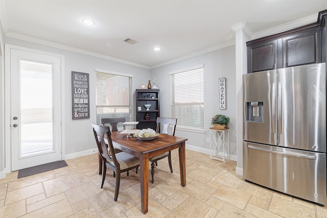 dining area with a wealth of natural light and ornamental molding