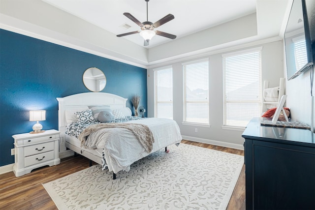 bedroom with ceiling fan and dark hardwood / wood-style flooring